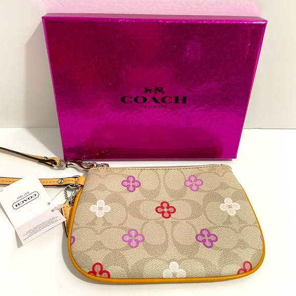 Coach Handbags - 🆕NEW-COACH WRISTLET IN FLORAL PRINT WITH COACH LOGO-C ON IT. VERY STYLISH.